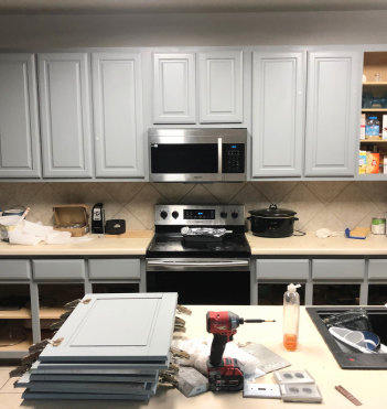 Kitchen cabinets undergoing color renovation for a refreshed look.